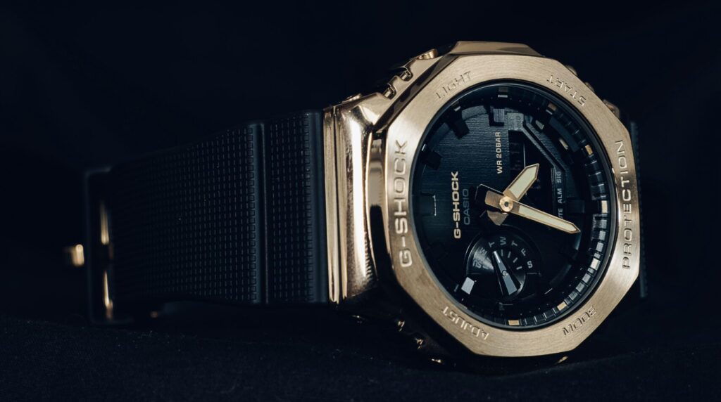 Casio G-Shock GM-2100 metal men's wristwatch with octagonal bezel on a dark background